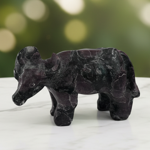 Black obsidian buffalo with marble bokeh background