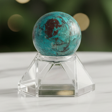 Chrysocolla sphere with marble bokeh background