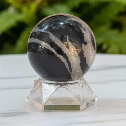 Crystal sphere with marble bokeh background