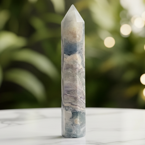 Fluorite point with marble bokeh background