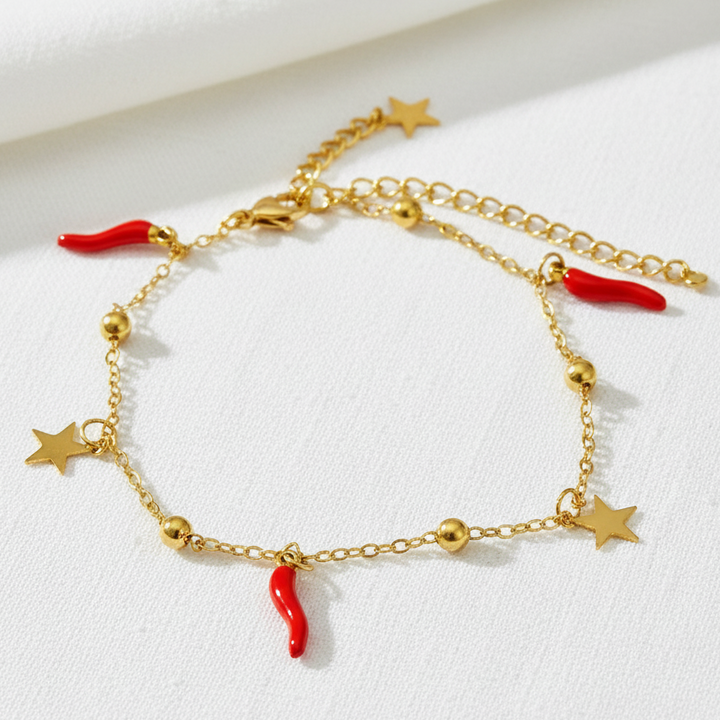 Gold anklet on white linen