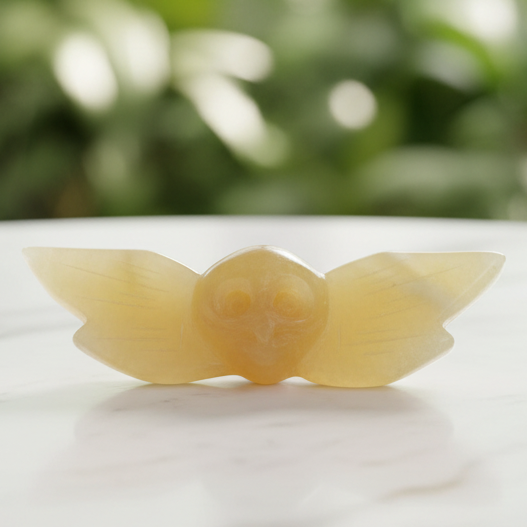Owl carving with marble bokeh background